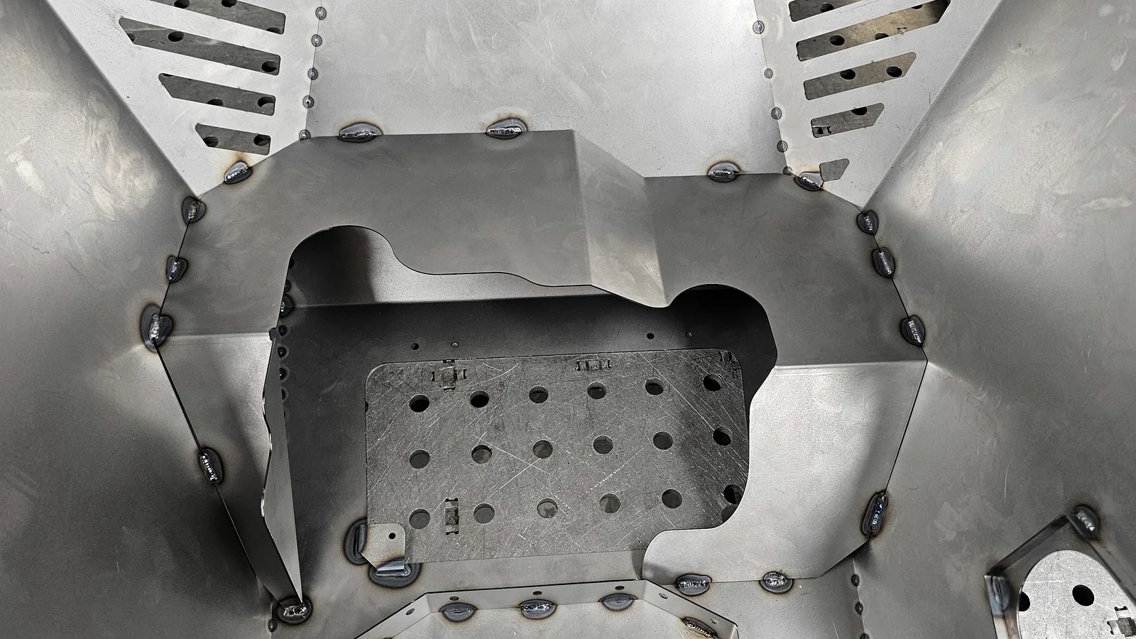 Inside a complex folded and welded sheet-metal assembly made by Hurstbourne Forge