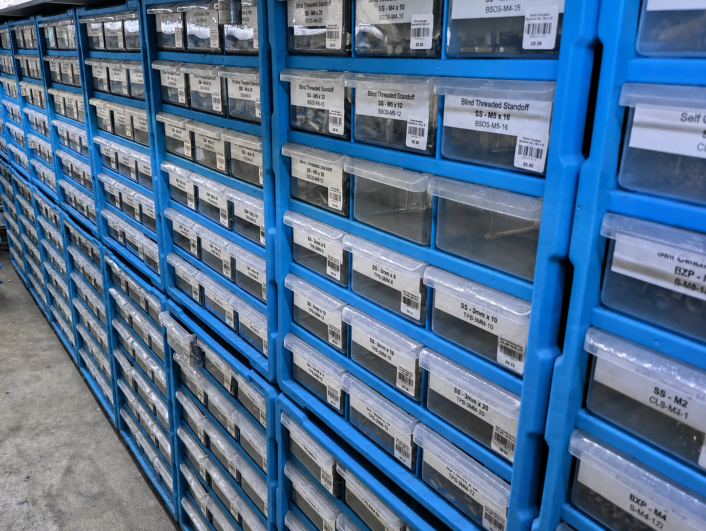 Stocked inserts and fitted hardware in blue workshop bins