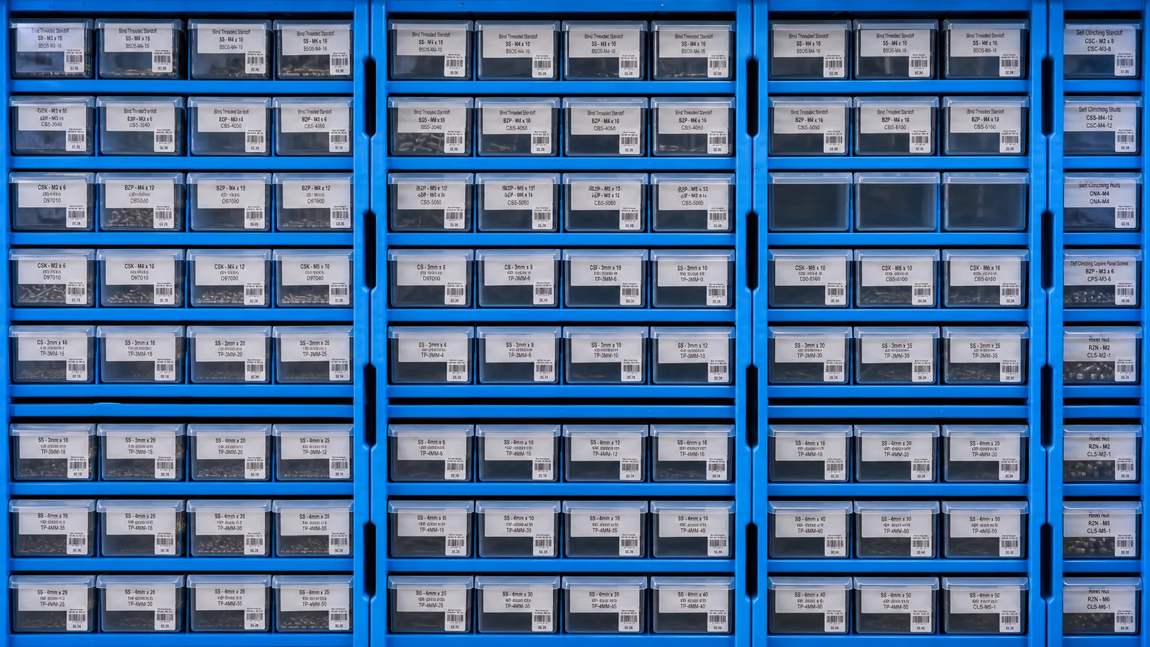 Blue workshop bins holding a stocked range of inserts, rivets and fitted hardware
