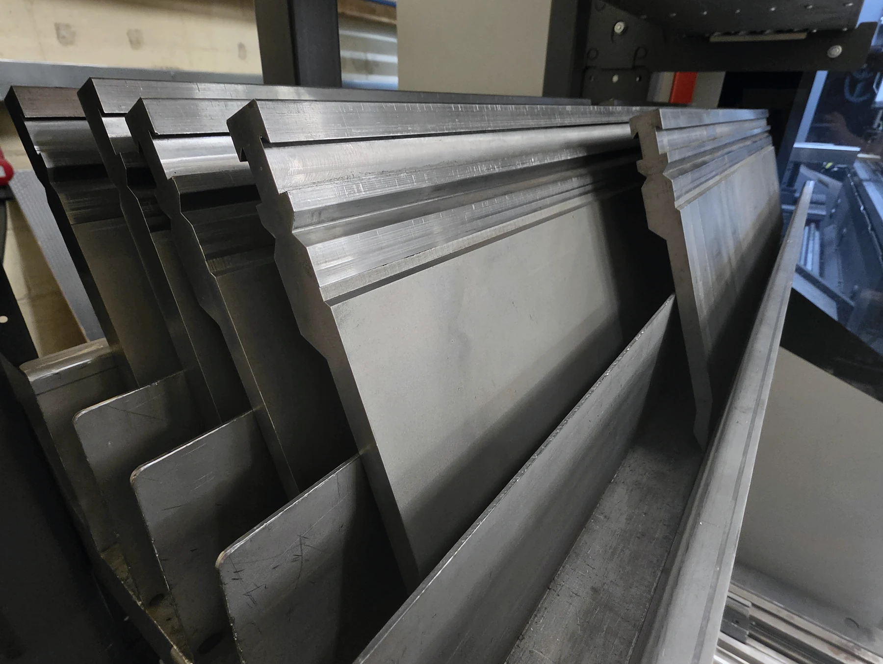 Formed sheet-metal parts ready beside a press brake