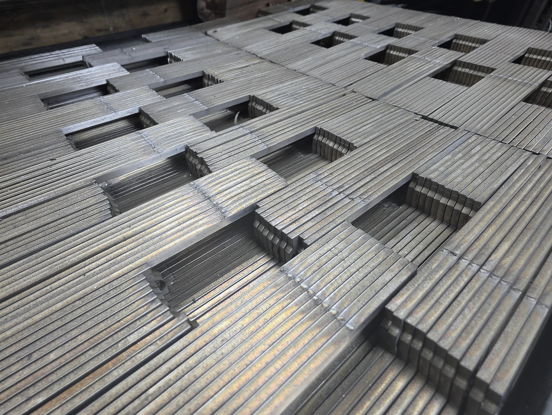 Nested sheet-metal components cut on the fibre-laser bed