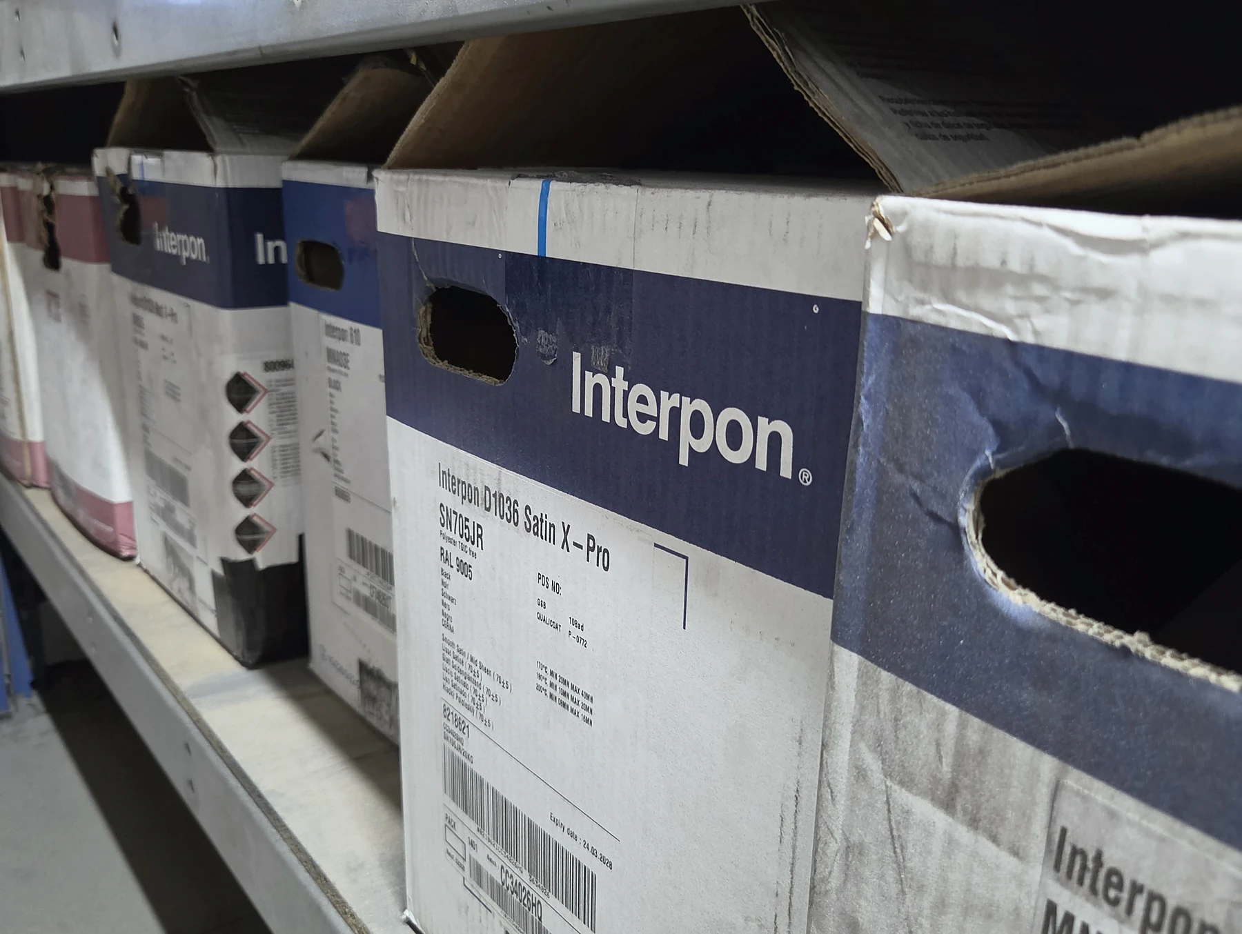 Boxes of stocked powder-coating colours in the Hurstbourne Forge workshop