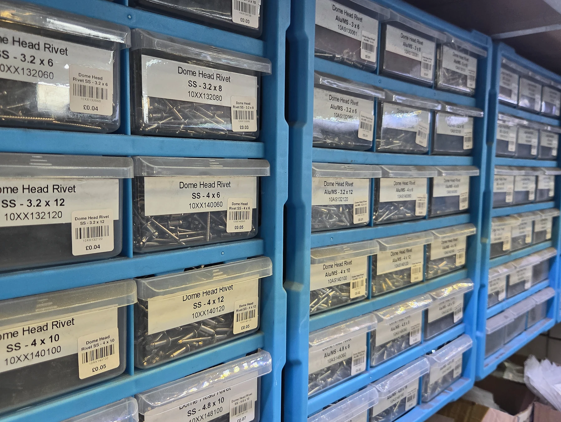 Blue workshop bins containing a range of blind rivets